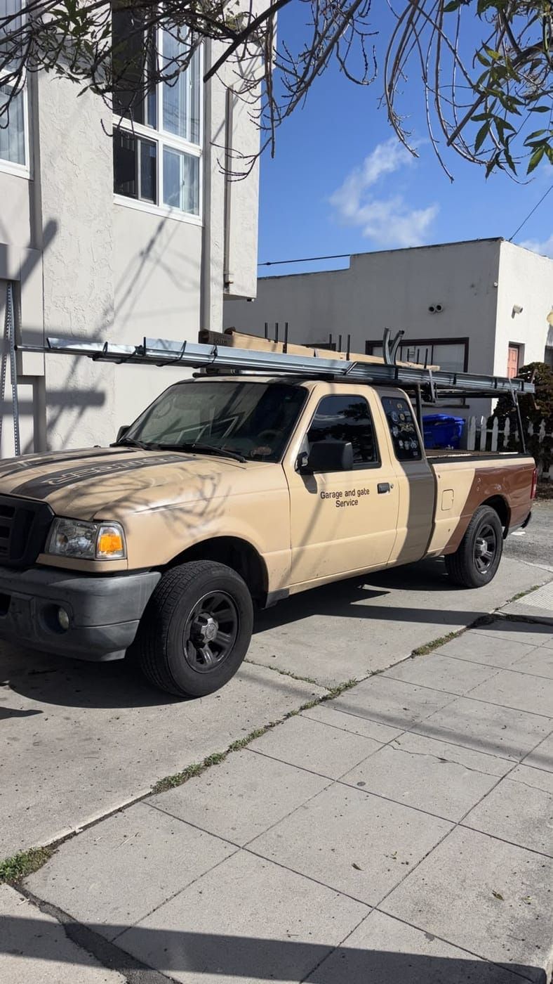 The Garage and Gate Palace service truck parked at the kerb, lettered Garage and Gate Service on the door, with a ladder rack and stock on the roof